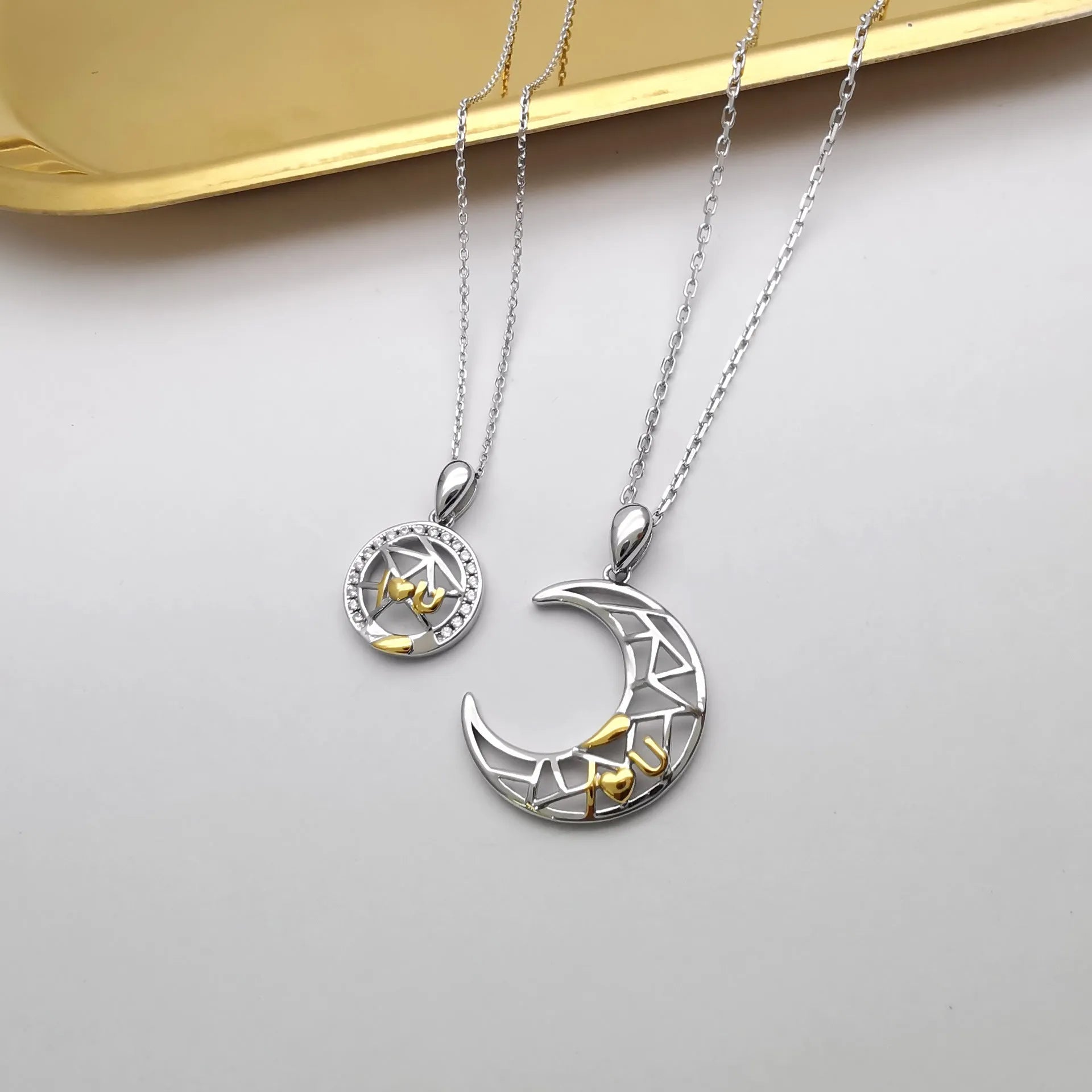 Copper sun and moon couple necklace with electroplated finish on a cross chain.
