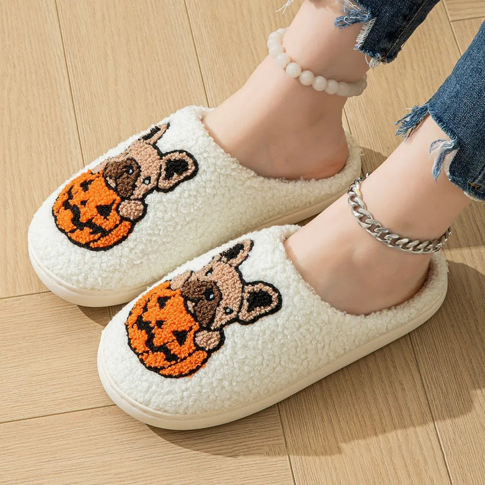Black and white Halloween pumpkin plush house slippers with non-slip rubber soles.