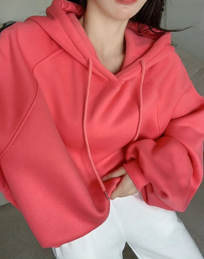 Watermelon red women's sleeveless hooded sweater made from mulberry silk on a hanger.