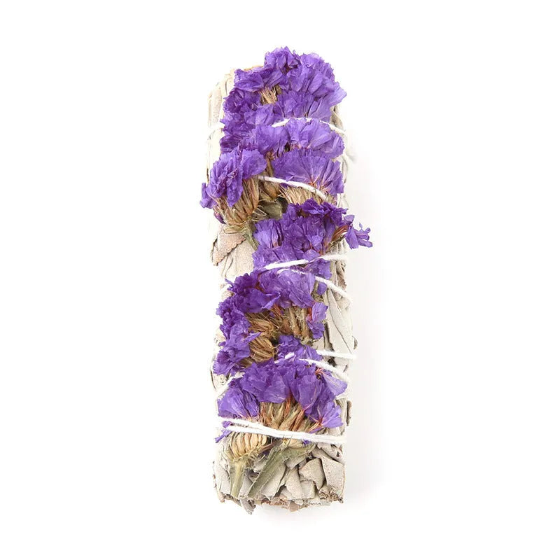 White sage and red rose petal colourful aromatherapy incense bundle on a wooden table