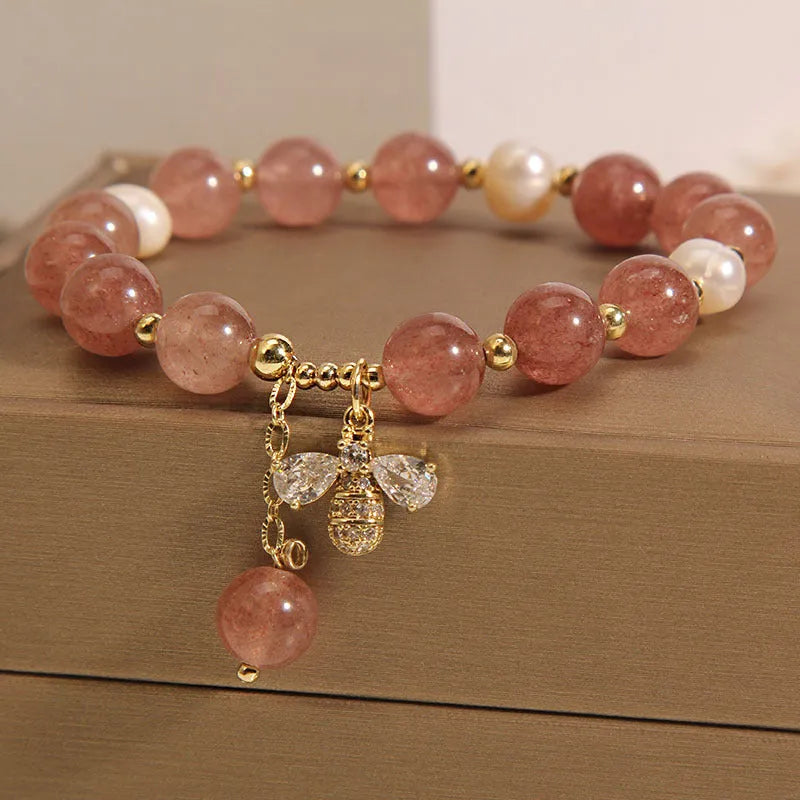Women's bracelet with pink strawberry quartz stones, white freshwater pearls, and zircon details on an alloy chain.