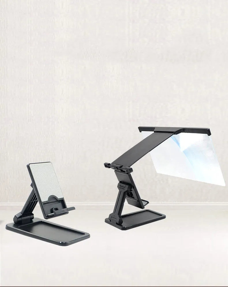 Black folding mobile phone screen amplifier with detachable holder on a desktop.