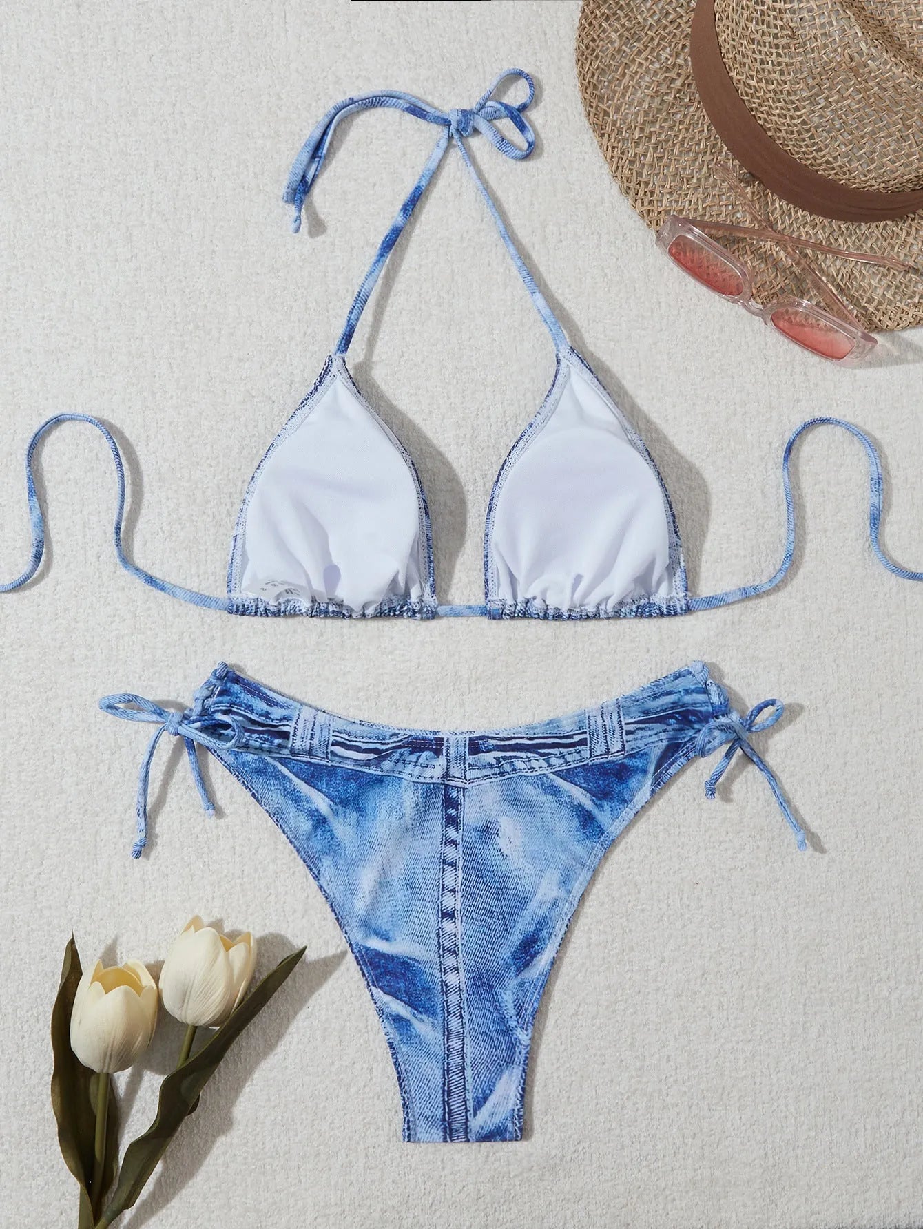 Denim blue printed women's bikini set with strap design on a white background.