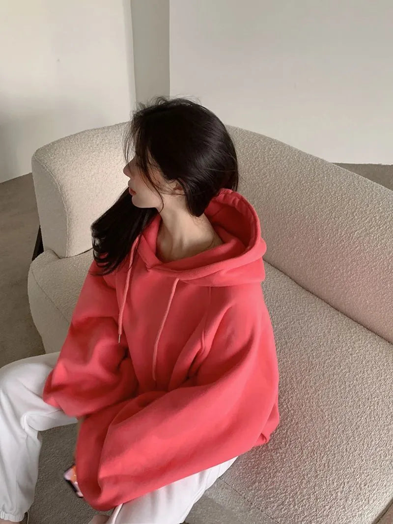 Watermelon red women's sleeveless hooded sweater made from mulberry silk on a hanger.