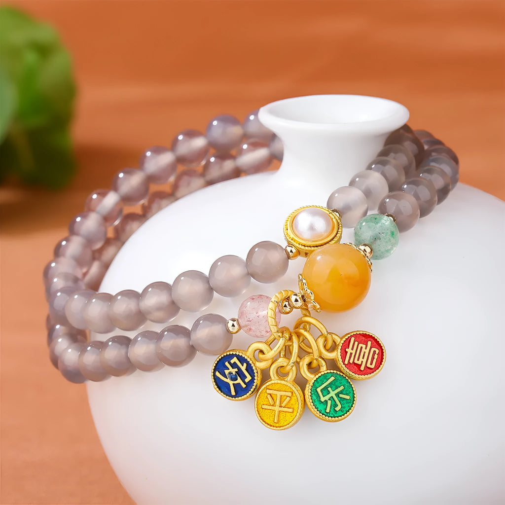 Natural gray agate two-circle bracelet on an adjustable cord, showing hand-polished stone detail.