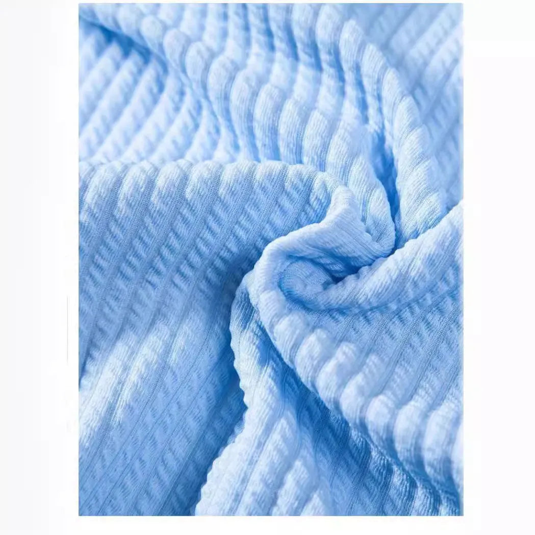 Men's loose fit short sleeve casual shirt in light blue, showing front view on a hanger.