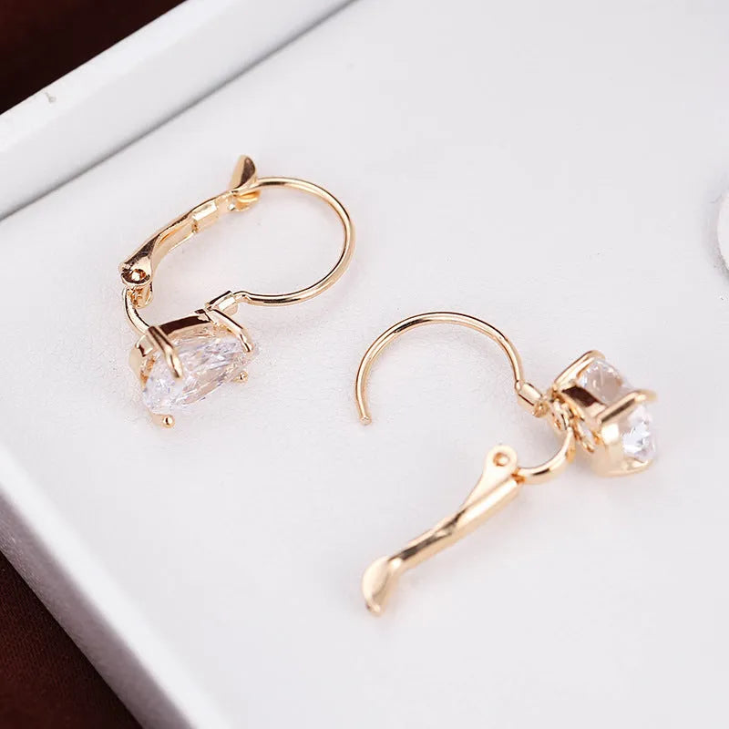 Gold and platinum drop-shaped women's metal earrings with a k-platinum inlaid gem