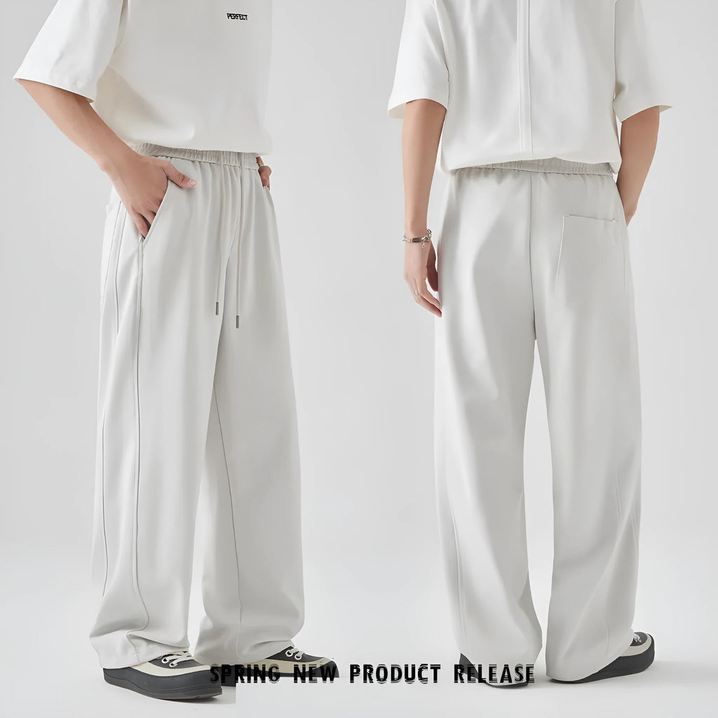 Men's grey high-waisted casual trousers with a lace-up front detail on a plain background.
