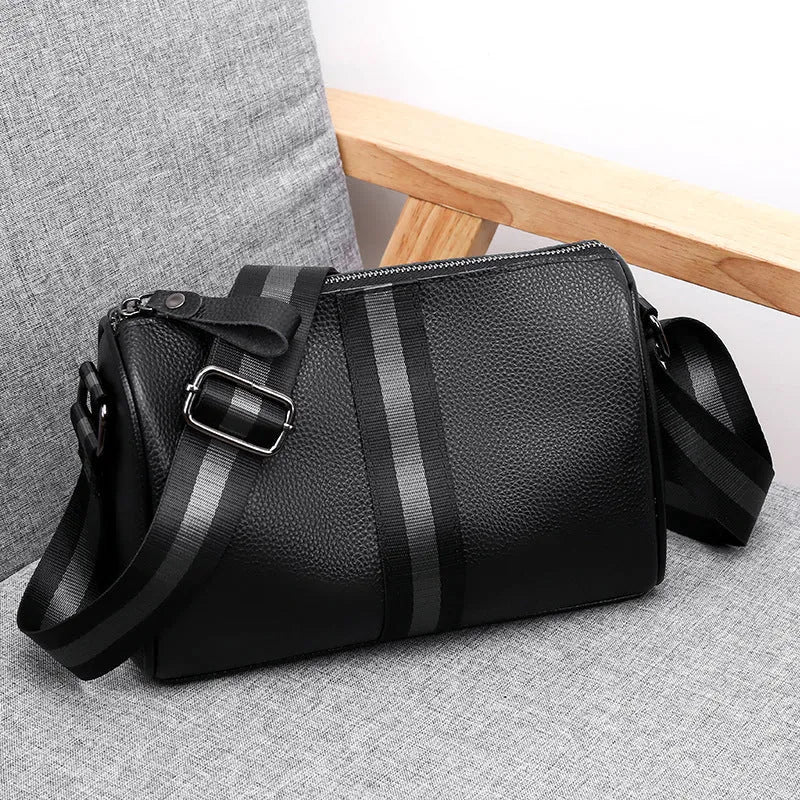 Black genuine leather one-shoulder crossbody bag showing 24cm width