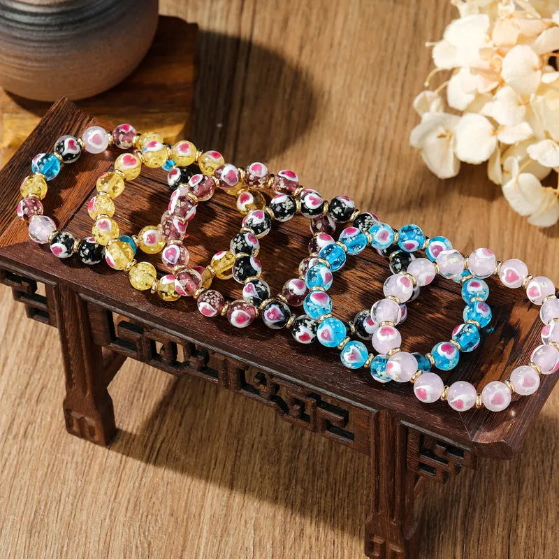 Handmade fluorescent glaze bracelet with swallowing gold beast motif on heart-shaped 10mm beads
