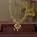 Women's green safety lock bell pendant bracelet with double-layer design and electroplated finish