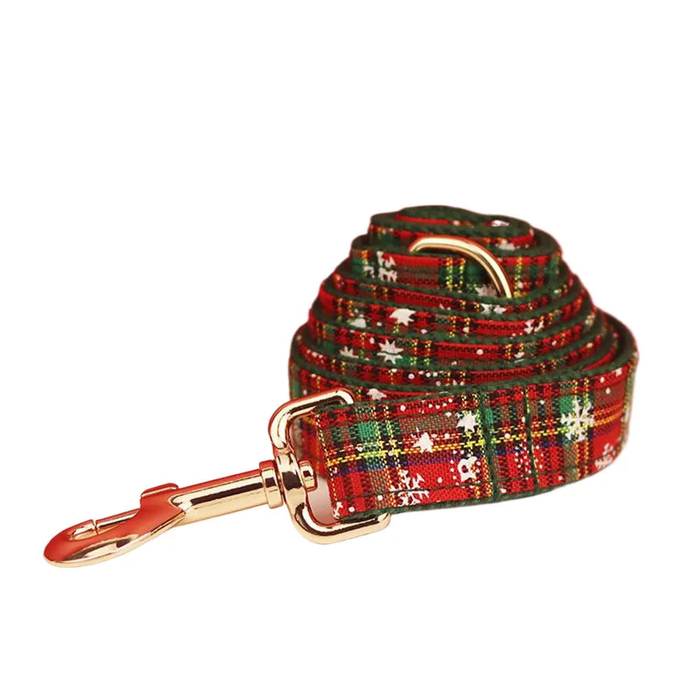 Green fabric Christmas pet collar and leash set with snowflake pattern, including a vest and decorative bow.