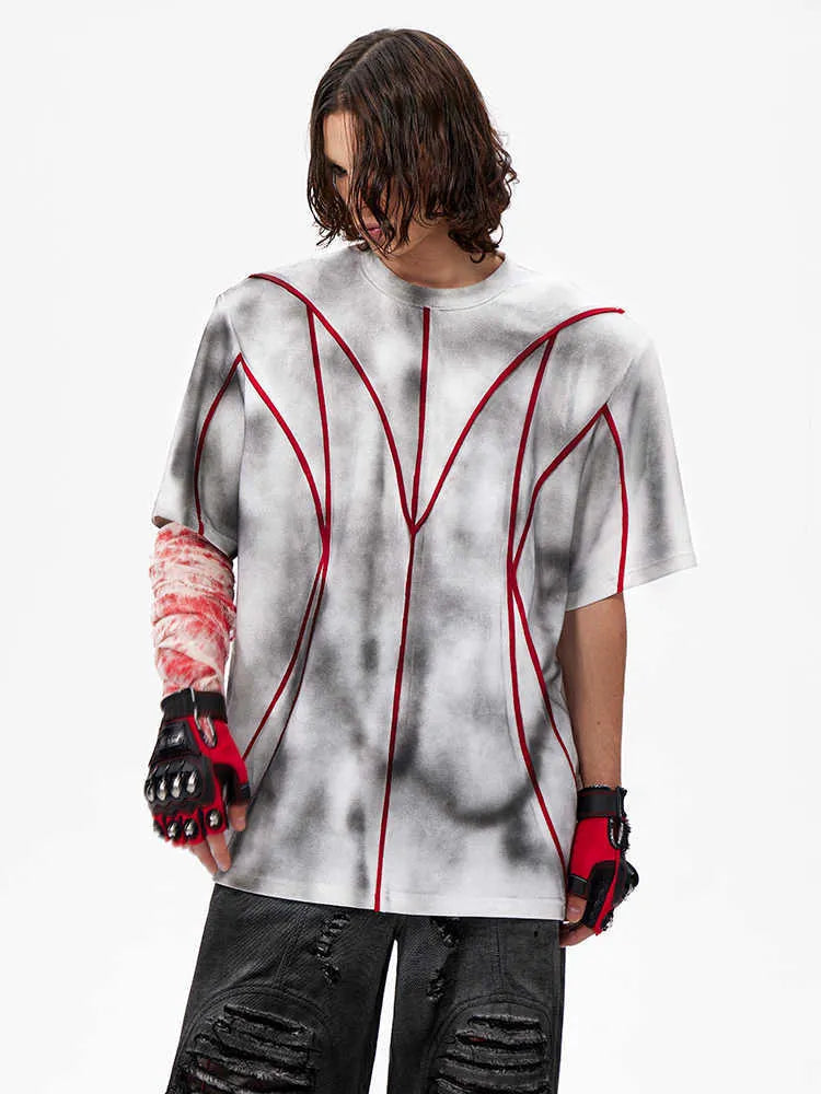 Women's short sleeve t-shirt with padded shoulders and three-dimensional line patchwork design on a round neck.
