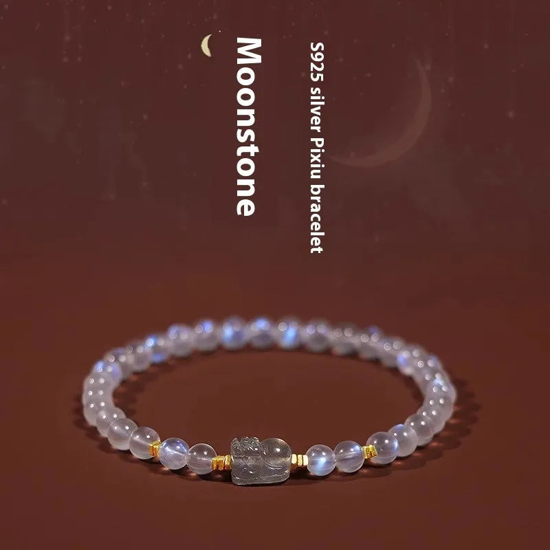 Close-up of a women's moonstone bracelet with zodiac animal design in a traditional Chinese style.