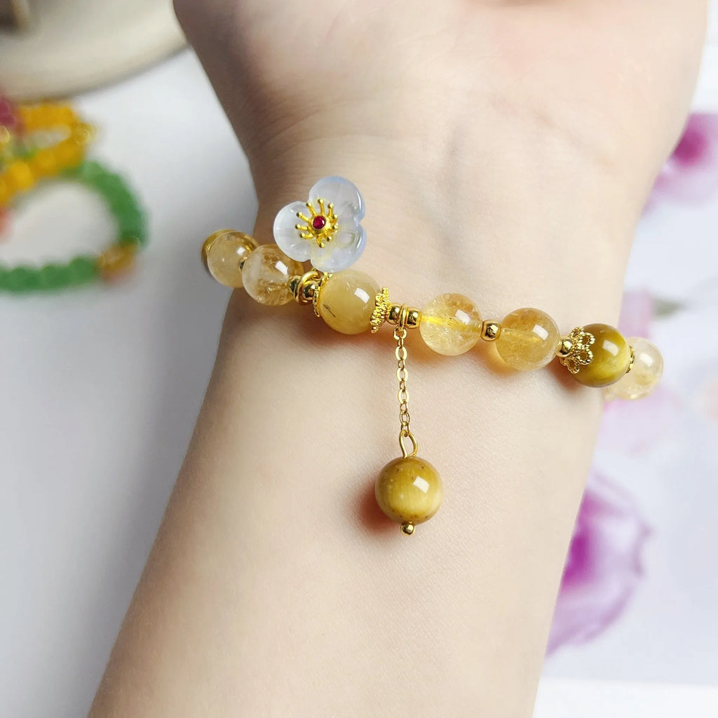 Handmade citrine colour crystal bracelet with floral and tassel detailing for women.