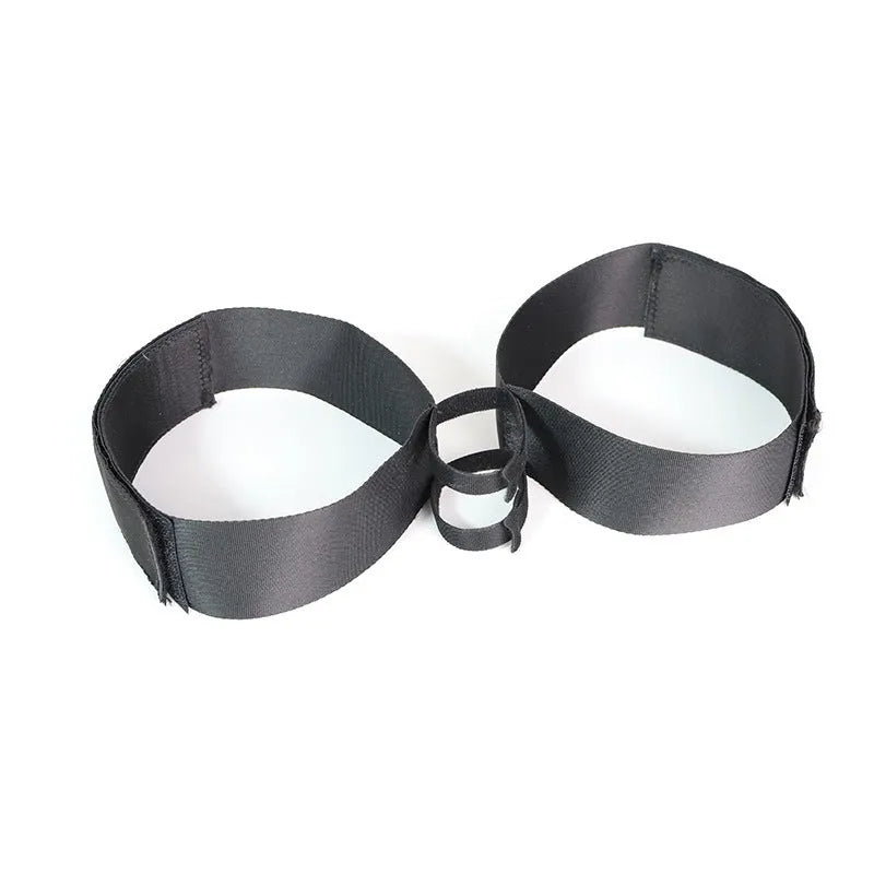 Black knitted appliance strap for women's sex toy tools on plain background