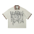 Men's loose blue cotton short-sleeved top with asymmetric lapel and graffiti print detail.
