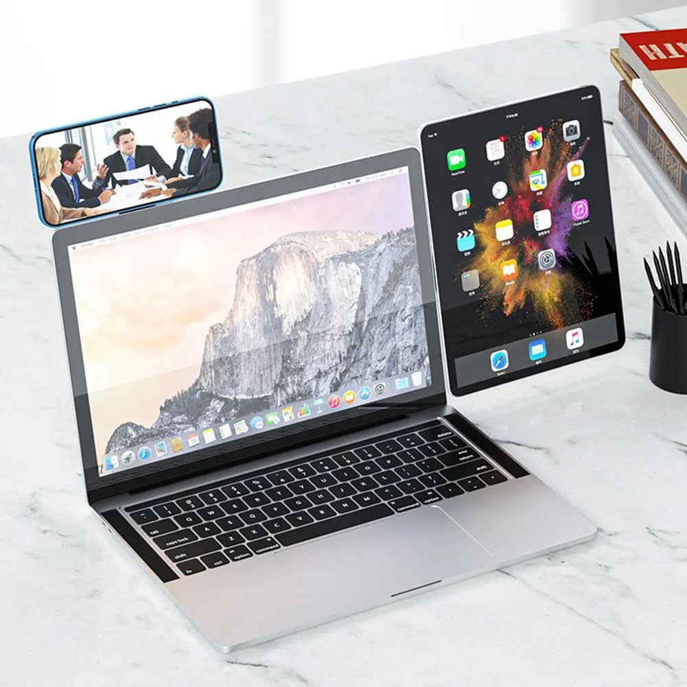 Black aluminium magnetic phone holder clipped to the side of a laptop screen with a smartphone attached.