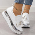 Women's black casual platform shoes with a tassel and distinctive muffin wedge heel on a white background.