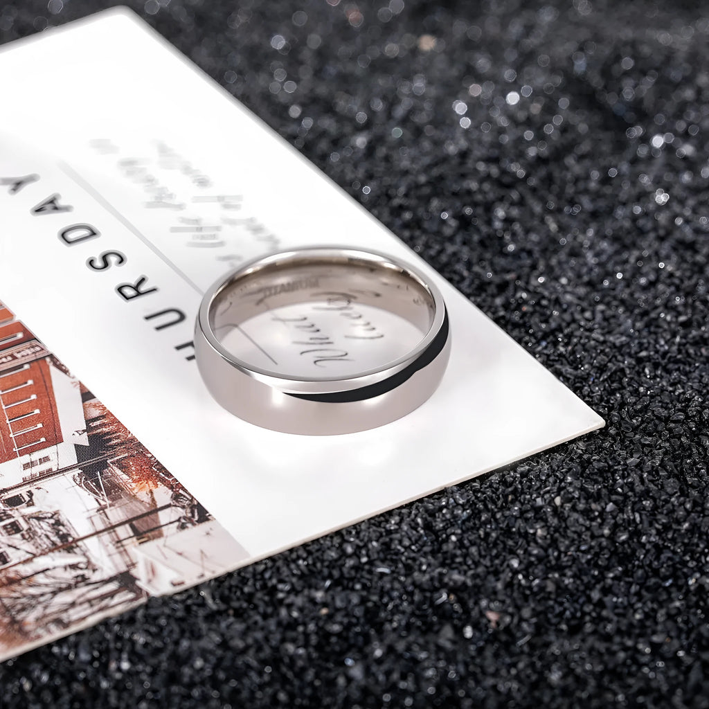 A polished silver titanium ring shown in three width options: 2mm, 4mm, and 6mm.