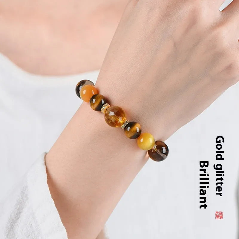 Close-up of a women's natural yellow bracelet with 10mm round artificial crystal beads on a string.