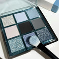 MUGELEEN nine-colour eye shadow palette open showing low saturation blue and complementary shades