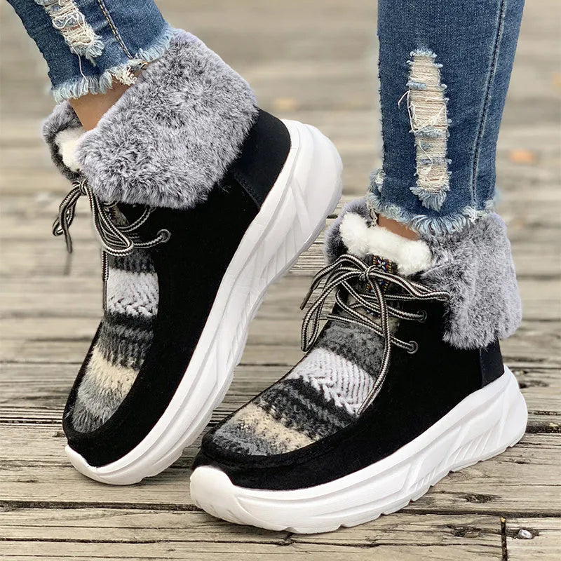 Women's mid-top lace-up snow boots in suede with a thick platform sole and plush lining.
