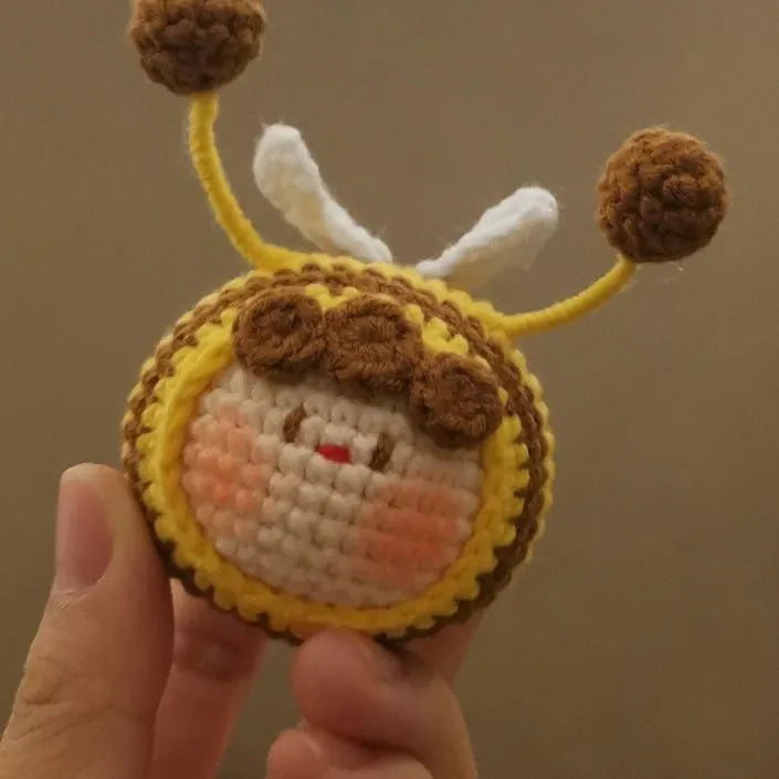 Handmade crocheted bee colony pendant accessory for a woolen doll.