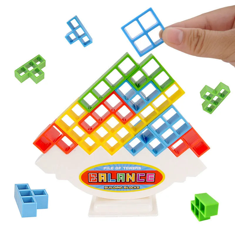 Plastic balance stacking board game with 16 colourful blocks, chassis, and base on a table.