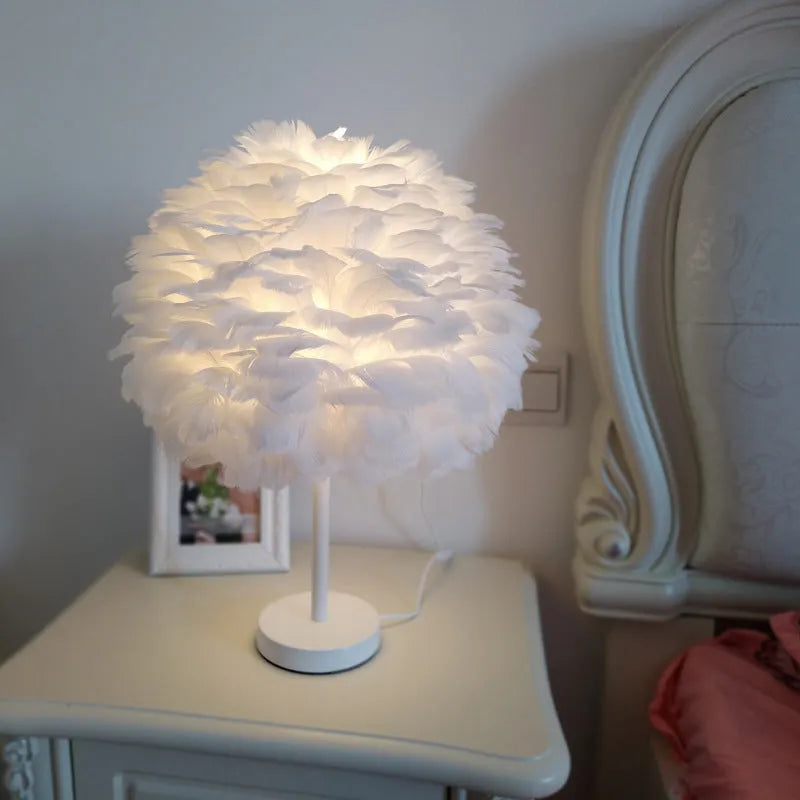 White handmade feather table lamp with metal base on a wooden desk, remote control visible, 30cm diameter