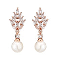 Geometric flower-shaped earrings with micro-inlaid zircon stones and pearl accents in gold, platinum, or rose gold plating.
