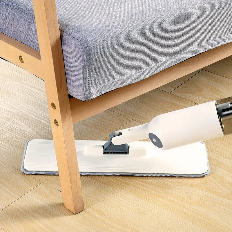 Flat cleaning mop with blue microfiber pad next to a white wringing bucket.
