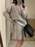Women's knitted sweater and shorts set with animal embroidery pattern in casual style