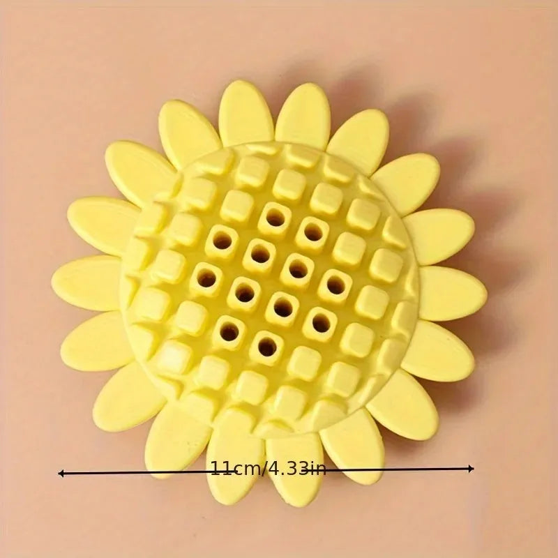 Yellow rubber sunflower-shaped dog chew toy measuring 7 cm across with textured petal surface