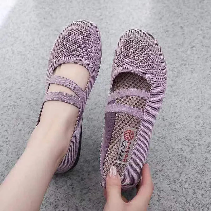 Elastic fabric slip-on flat shoes with round toe and non-slip rubber sole in purple, red, or black.