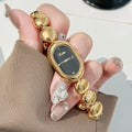 Women's oval gold tone watch with bracelet and 9mm case thickness
