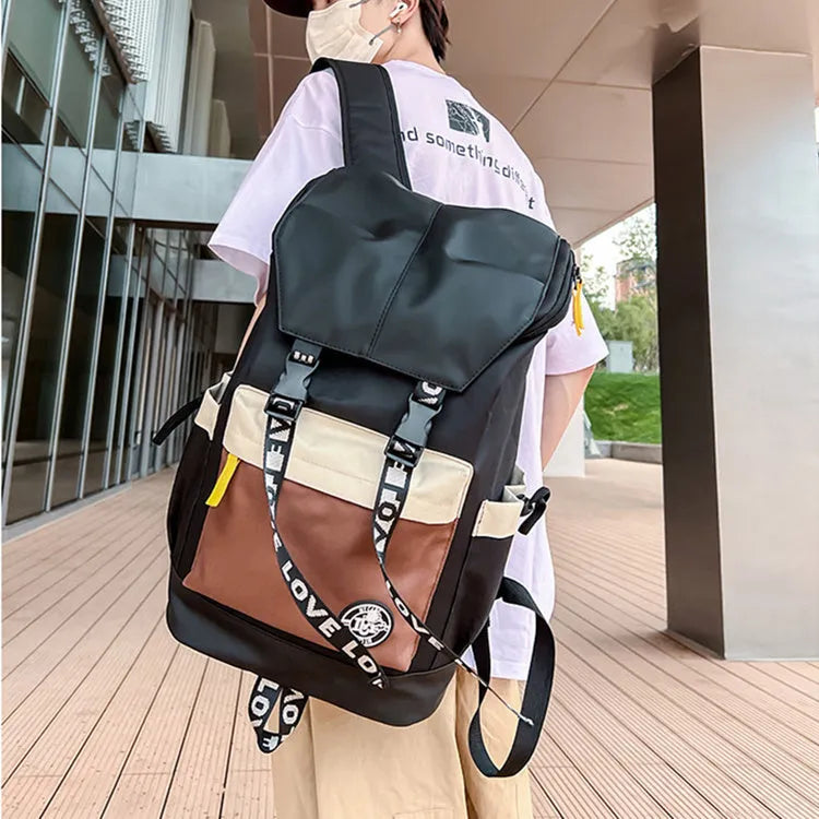 Oxford cloth school backpack showing black, green and red colour options with handheld and shoulder straps