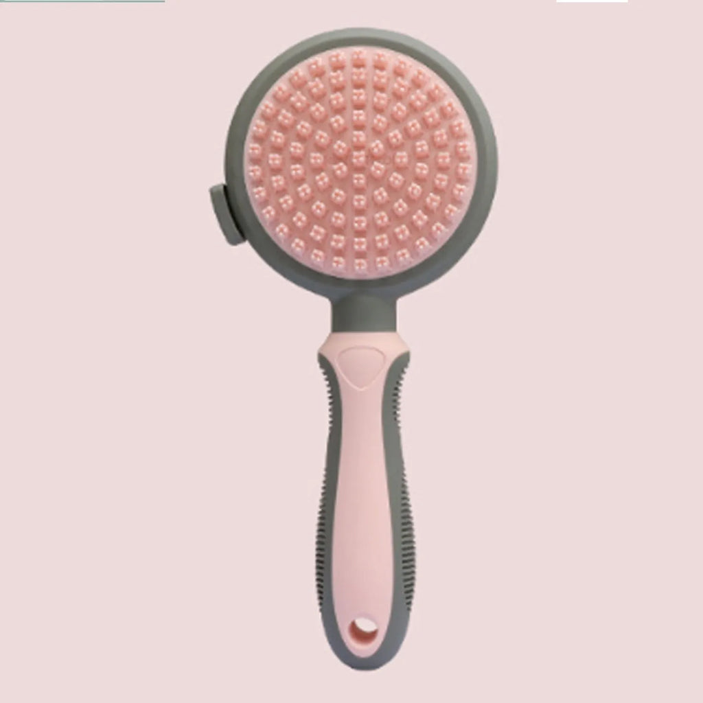Green and pink double-sided cat brush with a release button and flea comb for grooming.