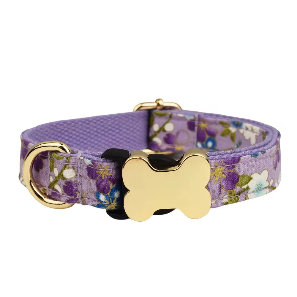 Flat printed grid nylon dog collar with a white bone-shaped plastic buckle on a green background.