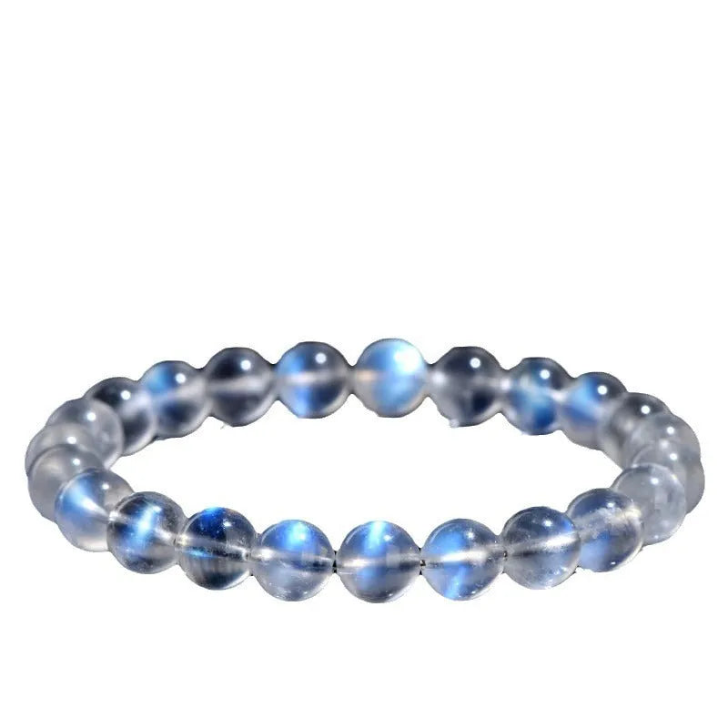 Natural cream body blue moonlight crystal bracelet showing grinding finish on wrist, available in single circle, strip or three ring designs.