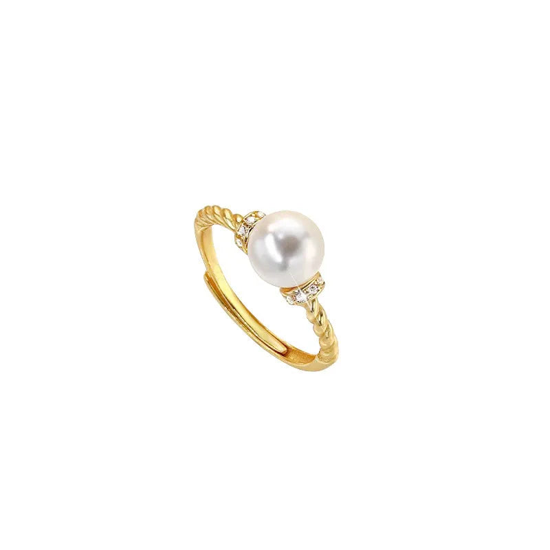 Adjustable antique twist copper ring with an inlaid pearl in gold colour.