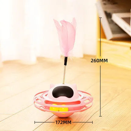 Pink cat tumbler turntable toy with a colourful baton on a flat surface.