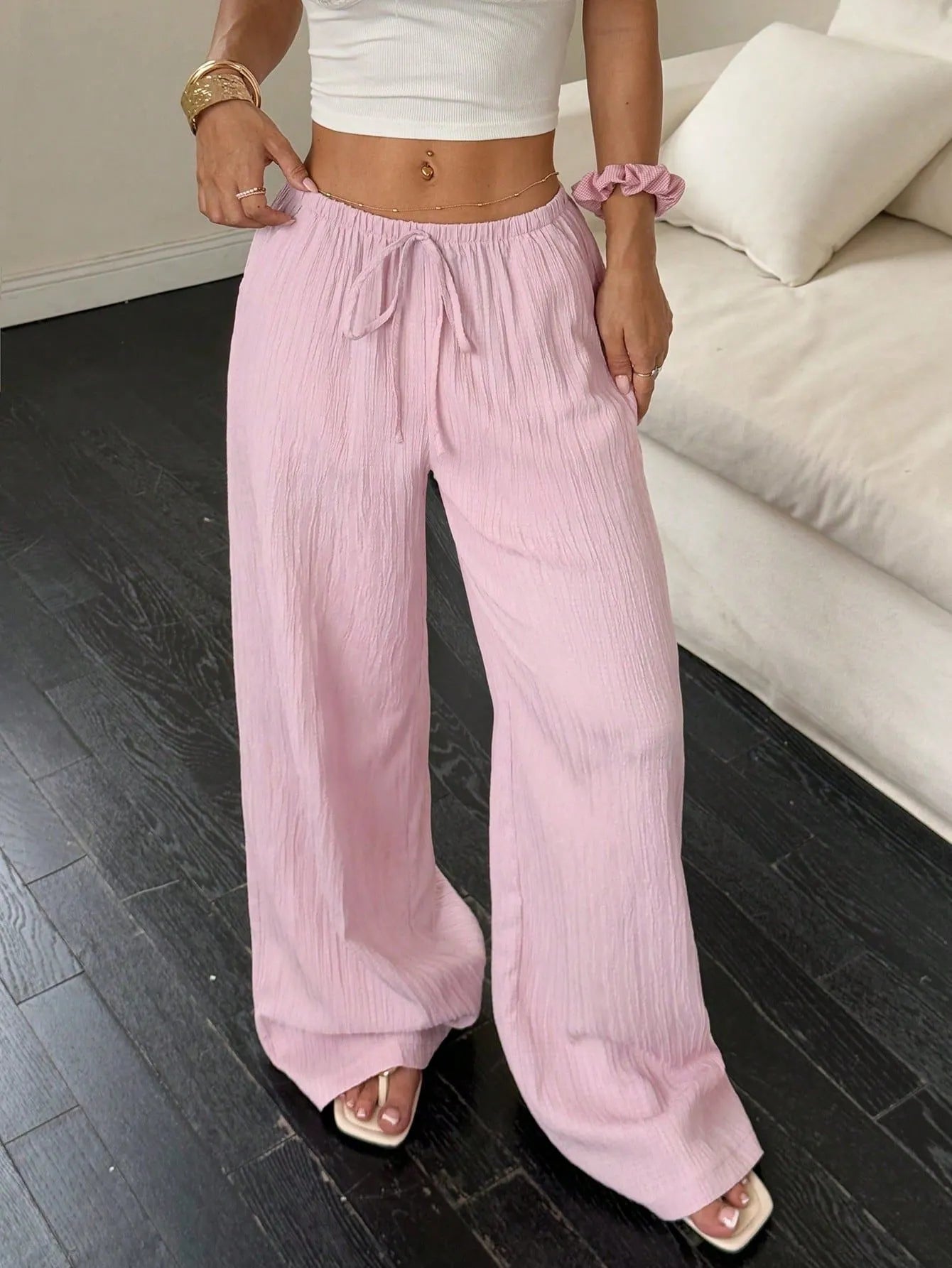Black wide leg women's trousers with a lace-up detail on the mid waist