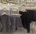 A woman's loose-fitting long sleeve knit sweater and matching wide-leg shorts set in a neutral colour.