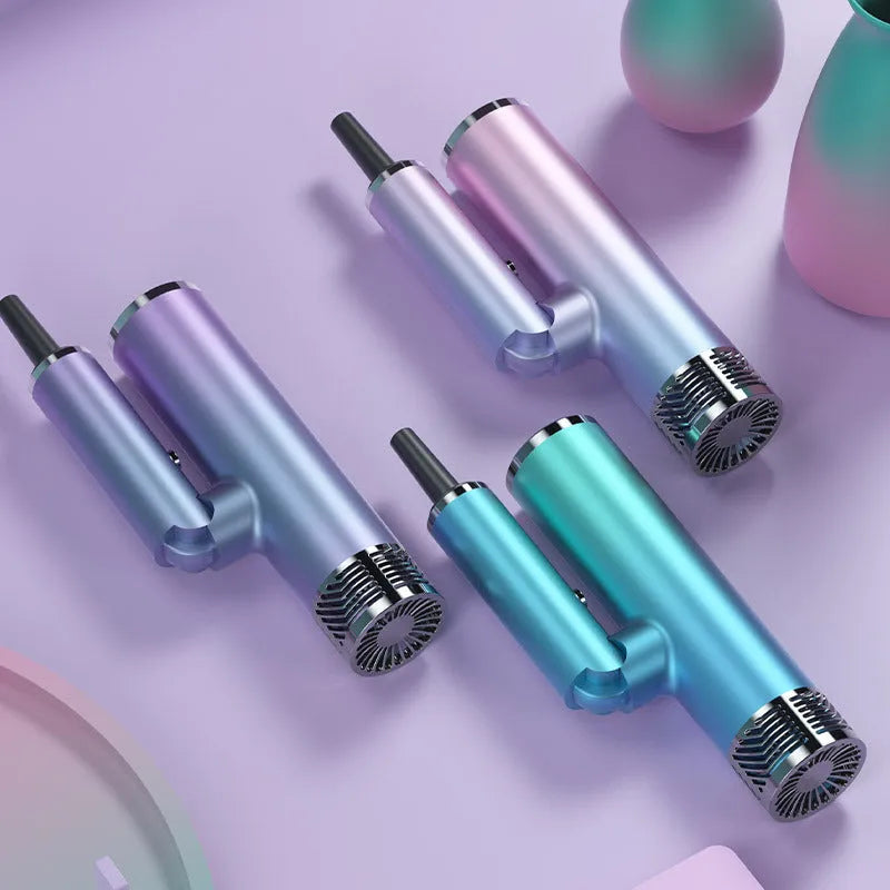 Green foldable hair dryer with collapsed handle next to a suitcase, demonstrating its travel-friendly portable design.