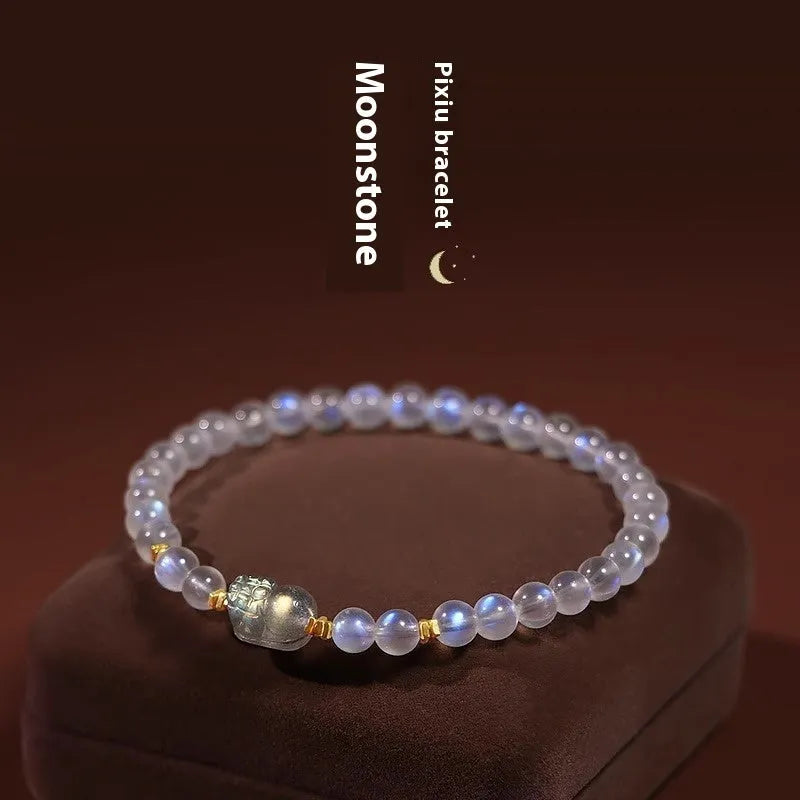 Close-up of a women's moonstone bracelet with zodiac animal design in a traditional Chinese style.
