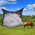 Woven grid horse feeding bag in black hanging, suitable for cattle and sheep.