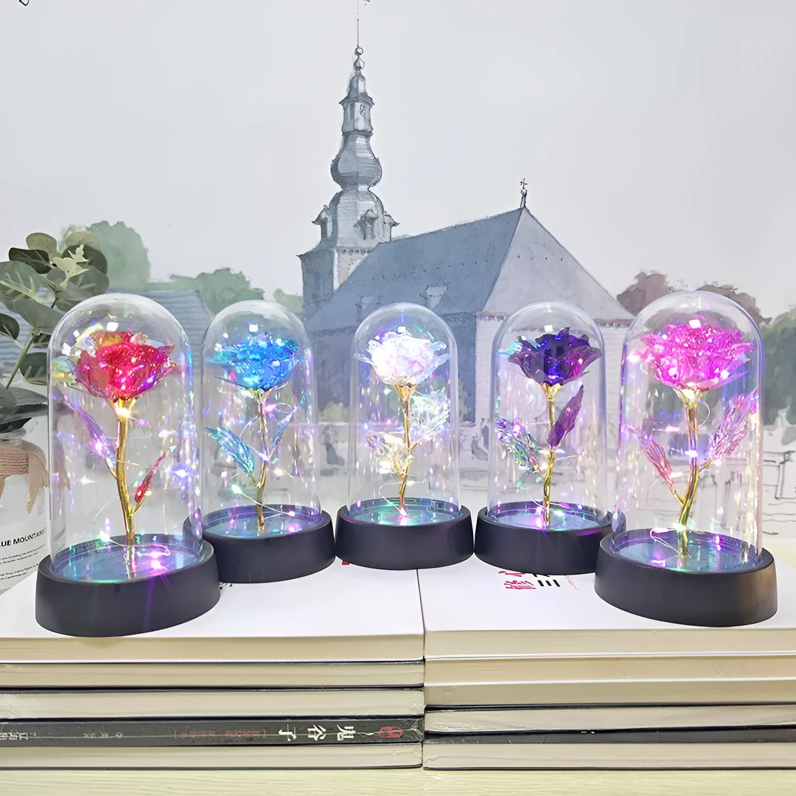 Small night lamp with coloured glass cover and plastic flowers on a black plastic base.
