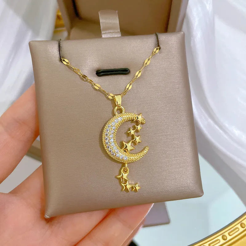 Stainless steel necklace with diamond-covered moon geometric pendant and tassel detail.