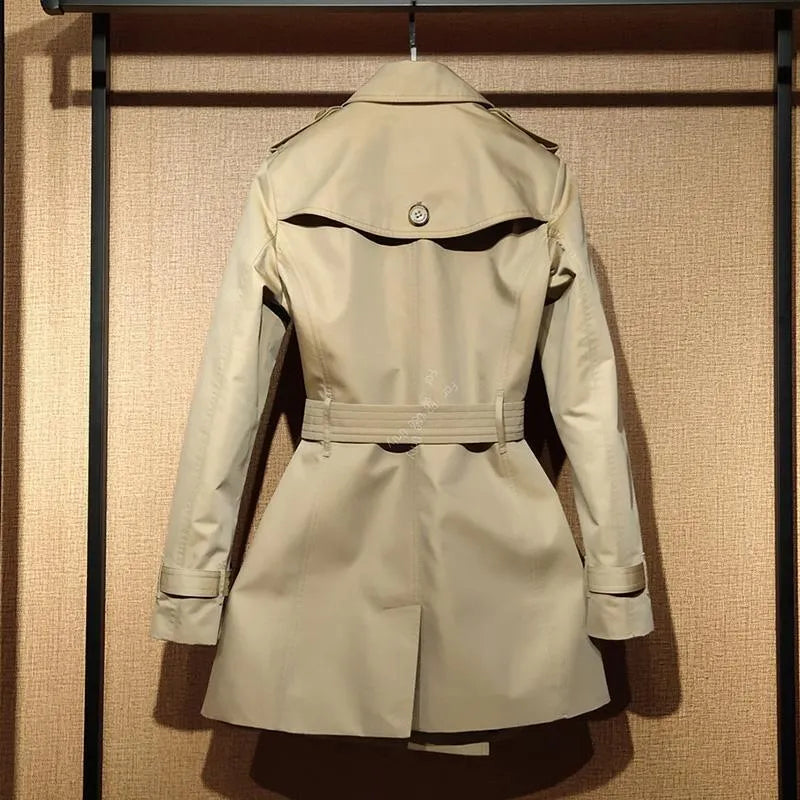 Khaki double-breasted women's trench coat with flight sleeves, shown on a hanger.